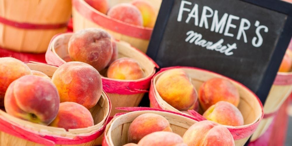 Baskets of peaches at a farmer's market.