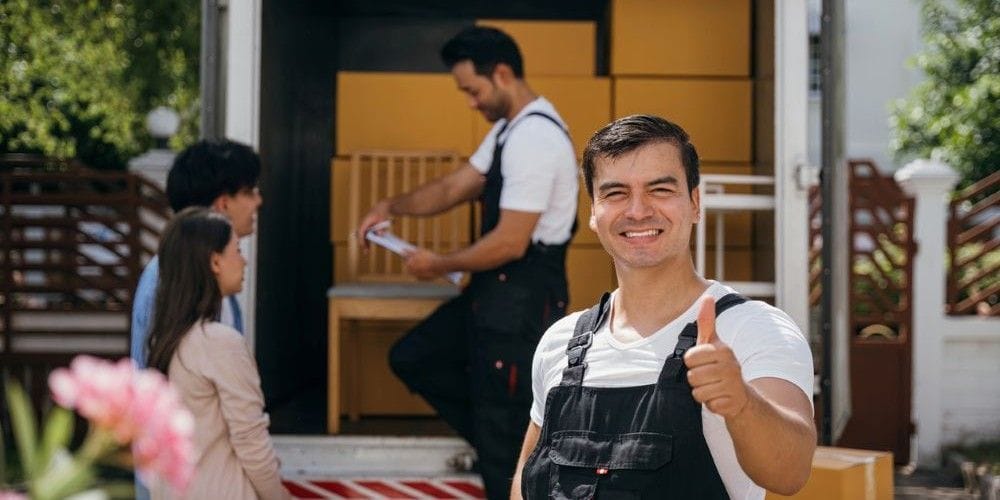 Men helping a family move to a new home.
