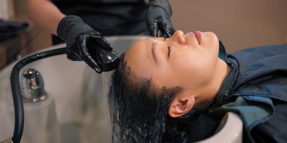 Woman getting her hair shampooed.