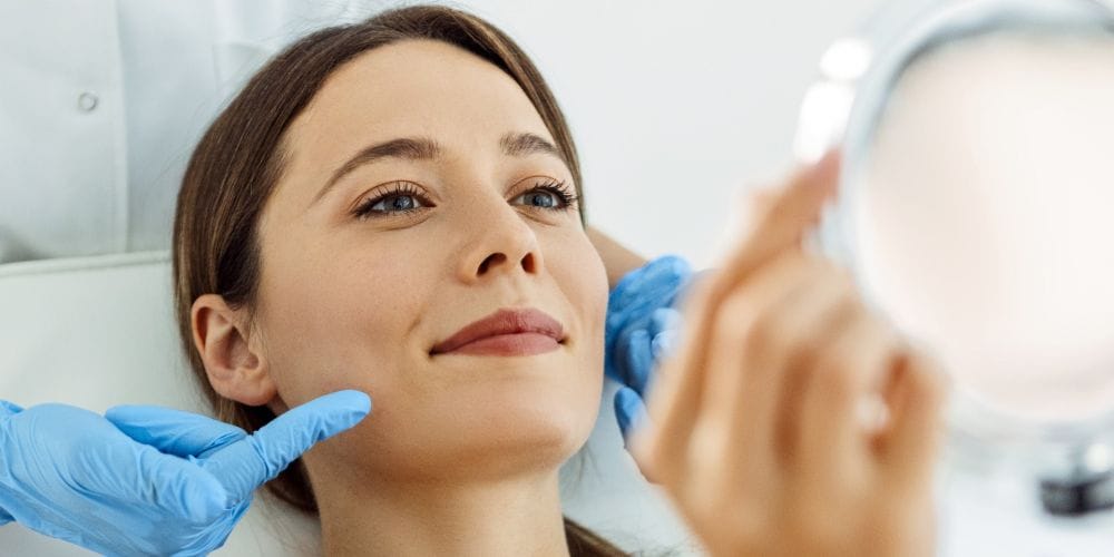 Patient seeing the results of the treatment at a local medical spa clinic.