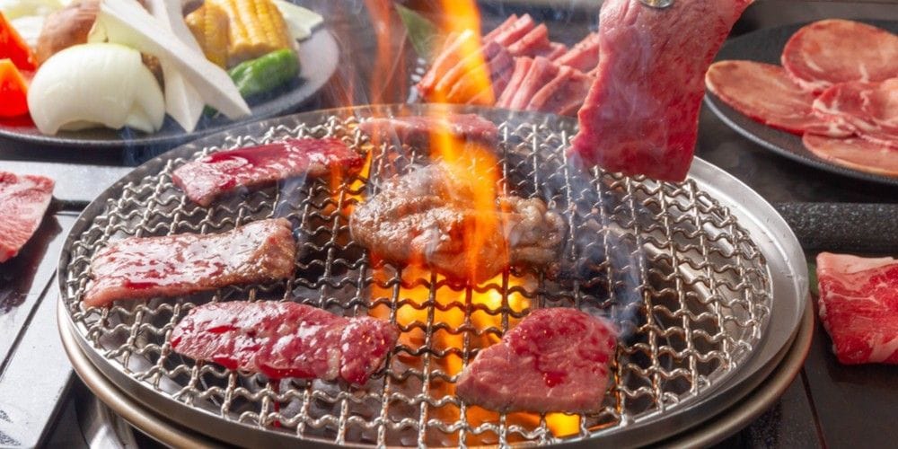 Grilling meat at Korean BBQ.