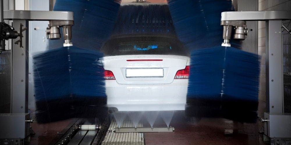 Car getting cleaned at a car wash.