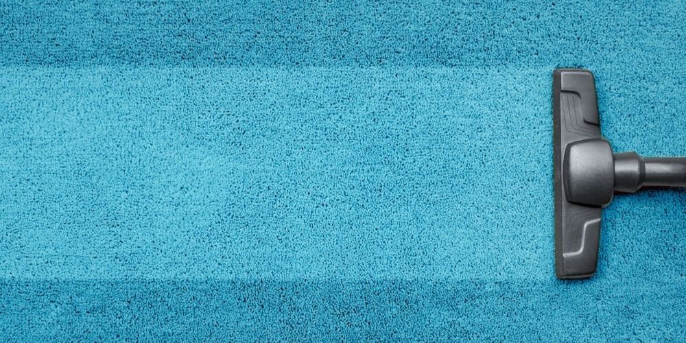 Vacuum cleaning the carpet.