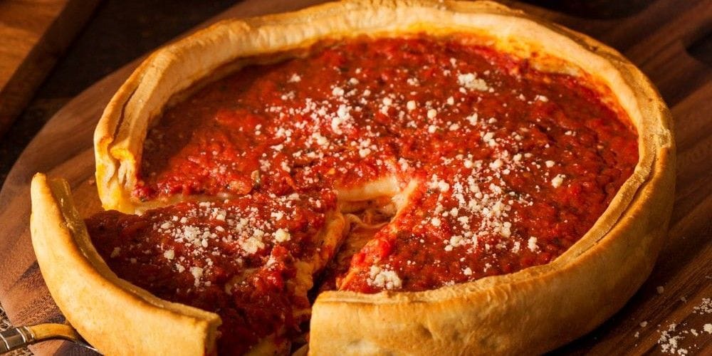 Chicago style deep-dish pizza served on a table.