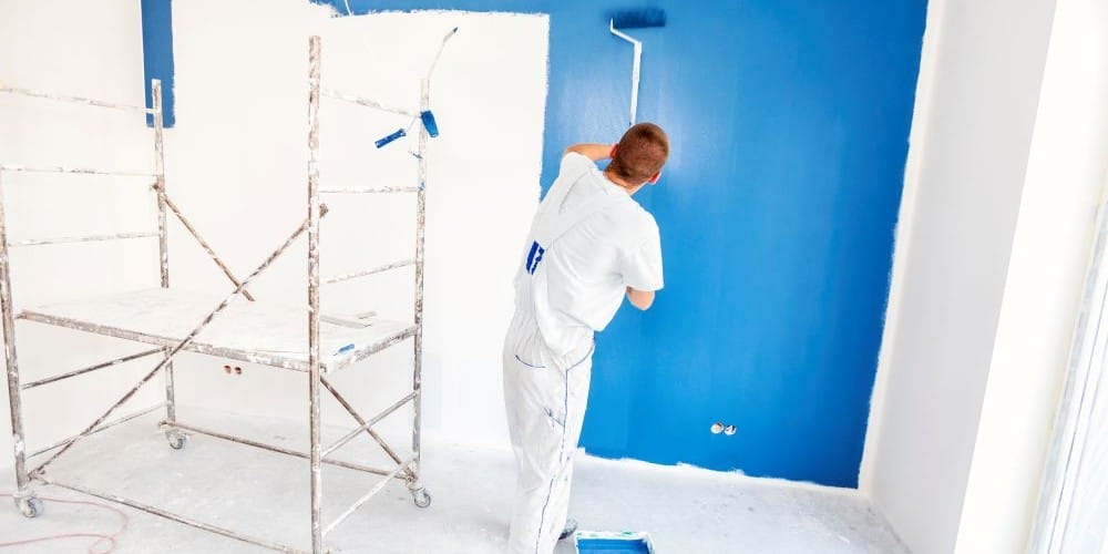 A man painting a house.