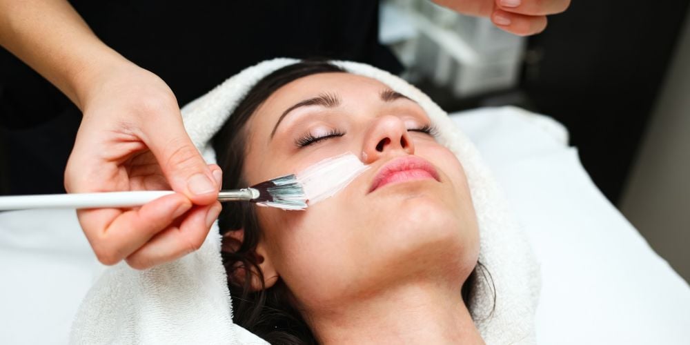 Woman getting a facial at a spa.