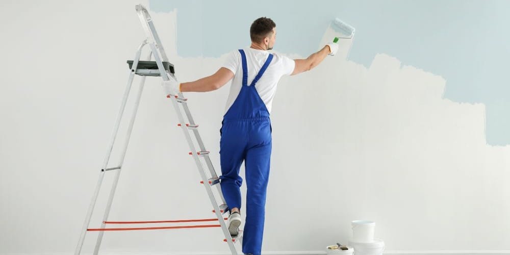 Painter painting a wall.