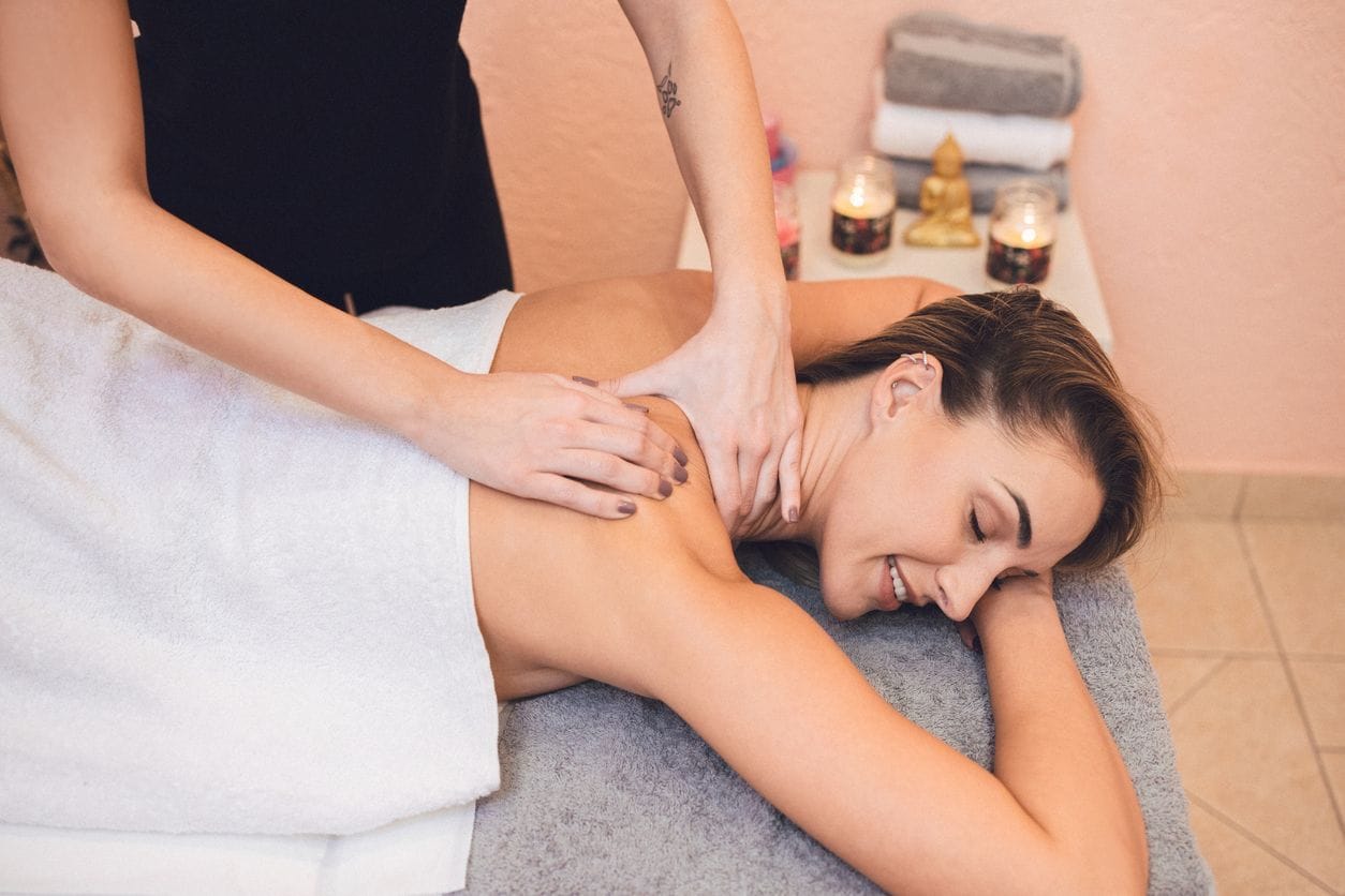 Woman getting a massage from a female massage therapist.