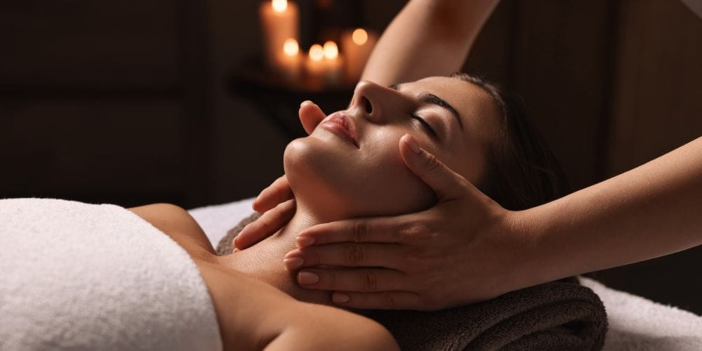Woman receiving a face massage.