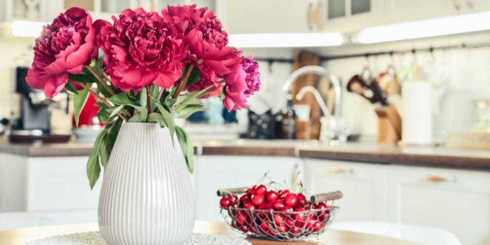 Beautiful bouquet of colorful flowers in the kitchen.