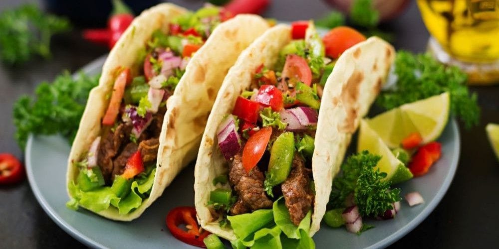 Traditional Mexican tacos served at the table.